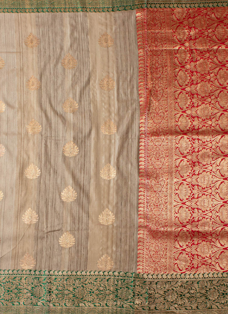 Beige color tussar silk saree with red and green border