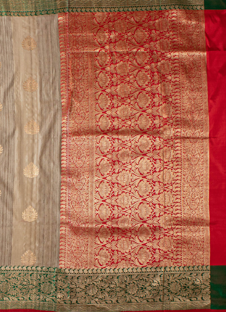Beige color tussar silk saree with red and green border